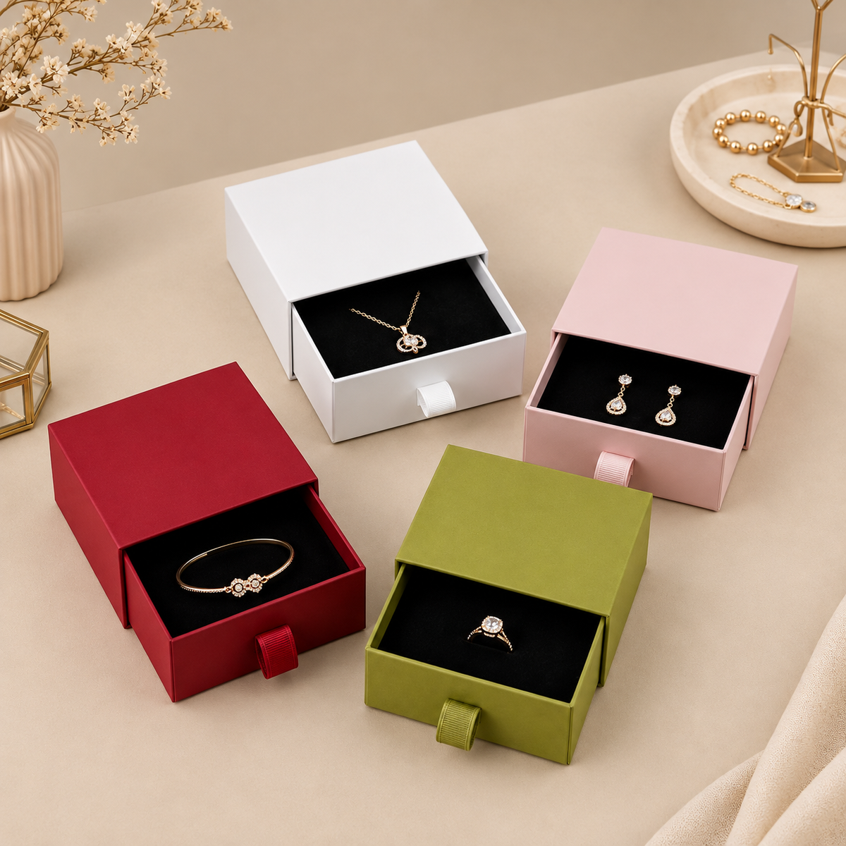 White, pink, red and grass green drawer boxes with jewelry inserts on display